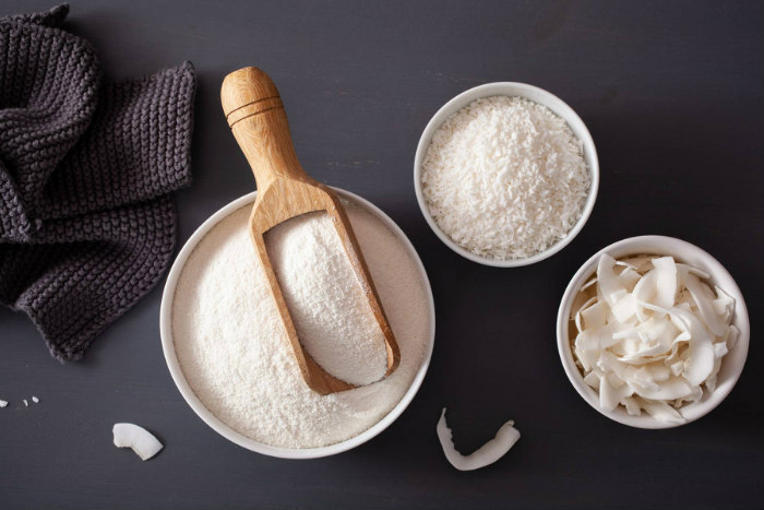 Aerial image of a kitchen counter full of coconut products like shreds and flour